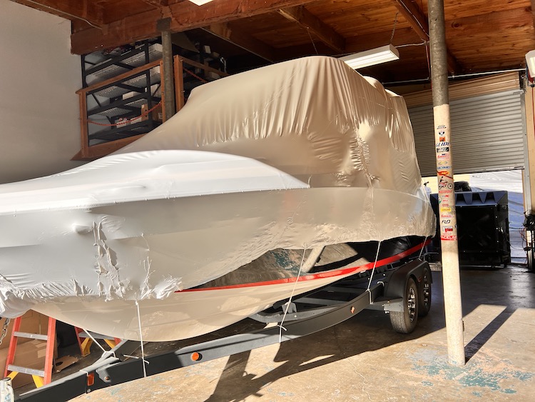 a single boat on a trailer shrink wrapped for winter.jpg