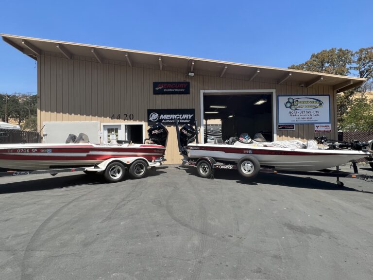 two fishing boats in front with Mercury outboard engine in front of the shop